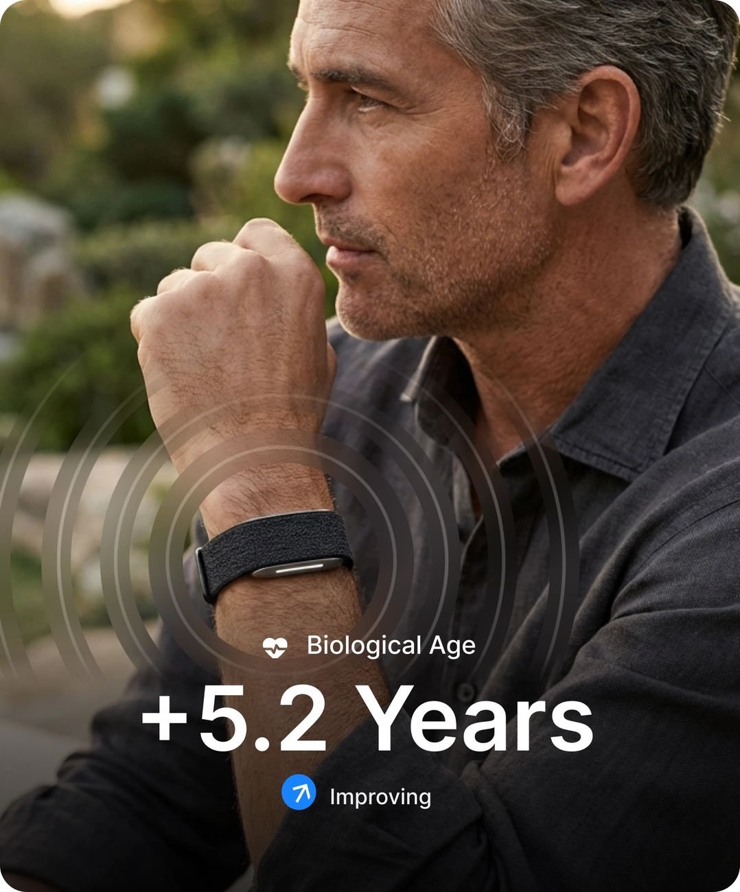 Man wearing the Hume Band with biological age and illness risk shown in the app
